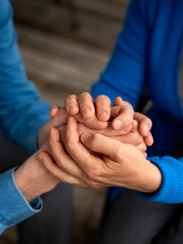 Close-up of caring handshake between patient and nurse